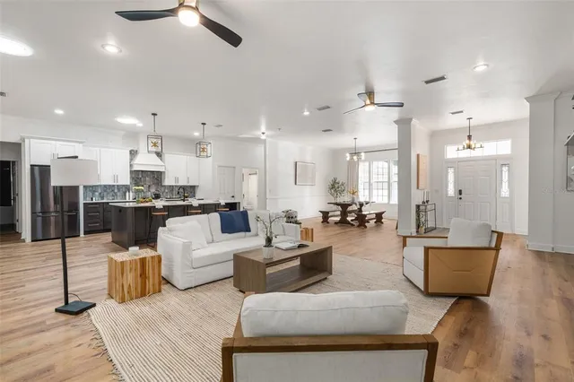a living room with furniture and kitchen view