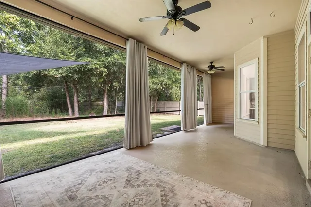 a view of a livingroom with a ceiling fan and a window