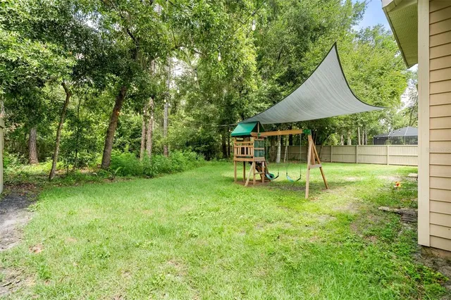 a view of a house with a backyard
