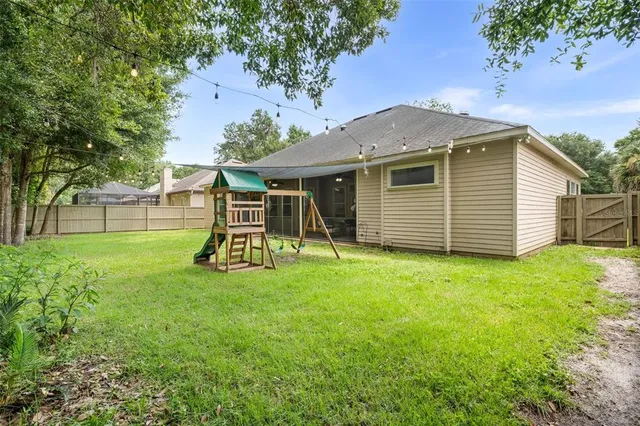 a view of a backyard with a garden and entertaining space