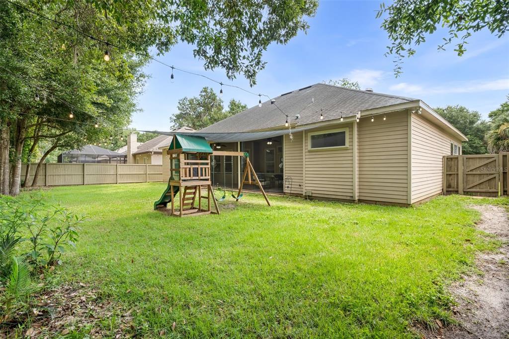 6326 Southwest 90th Street Gainesville, FL 32608 - Photo 36 of 44 a view of a backyard with a garden and entertaining space