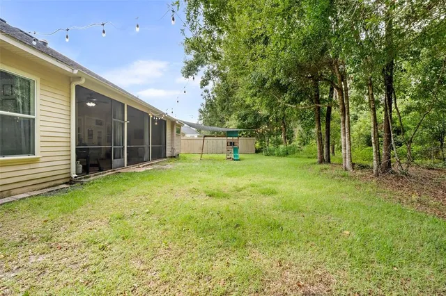 a view of a backyard with large trees