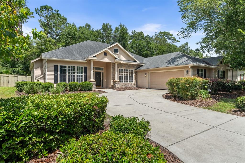 6326 Southwest 90th Street Gainesville, FL 32608 - Photo 40 of 44 a front view of a house with a garden