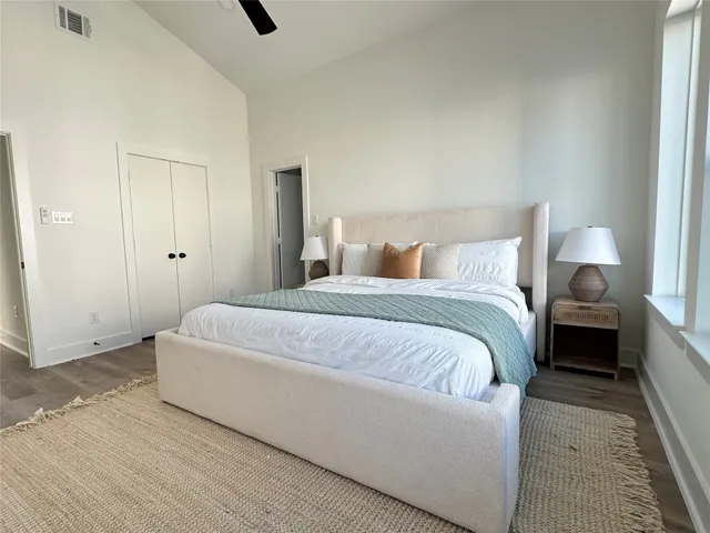 a bedroom with a bed and a night stand