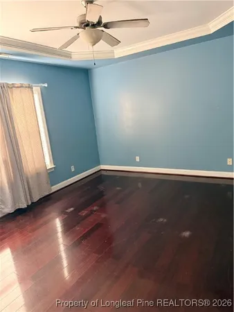 a view of room with window and wooden floor