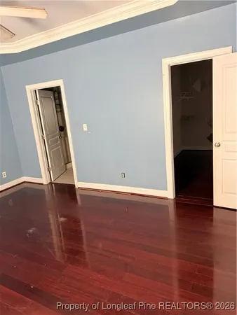 an empty room with wooden floor and closet