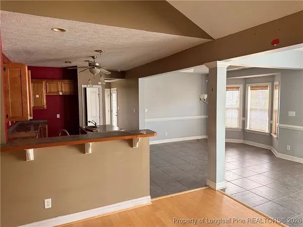a view of a hallway with a refrigerator and a sink