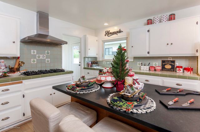 a kitchen with a dining table and chairs