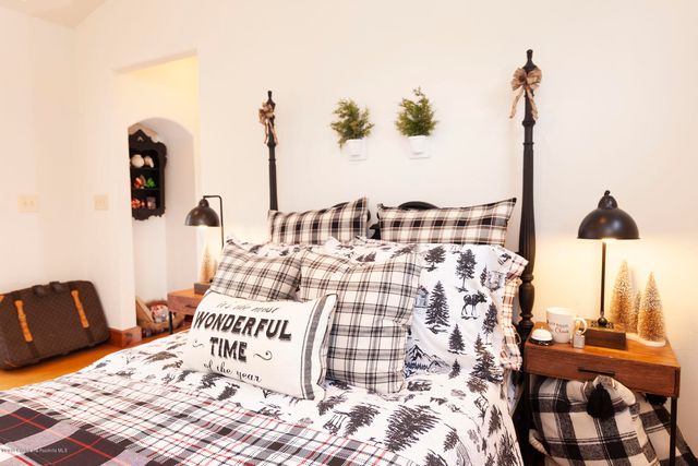a bedroom with double bed and a chandelier