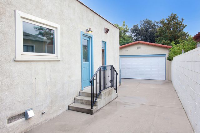 a view of patio with a table and chairs under an umbrella