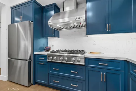 a kitchen with a sink stove and refrigerator