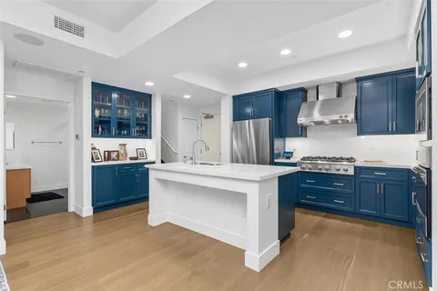 a kitchen with stainless steel appliances a refrigerator sink and microwave