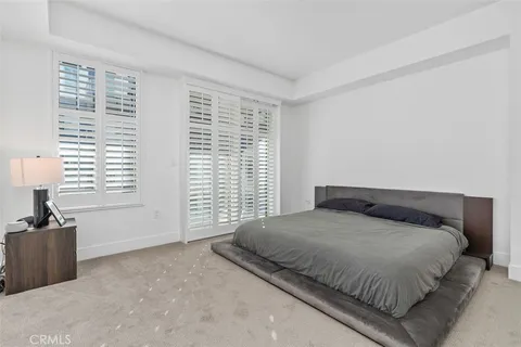a bedroom with a large bed and a large window