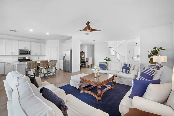 a kitchen with stainless steel appliances a sink a stove a table and chairs