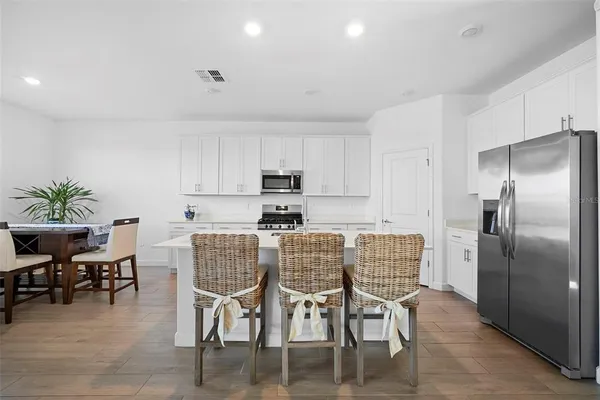 a kitchen with cabinets and wooden floor