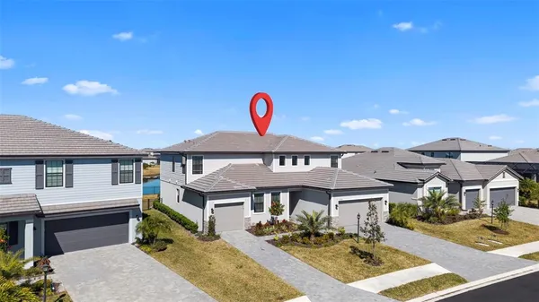 an aerial view of a residential building ocean and mountain view in back