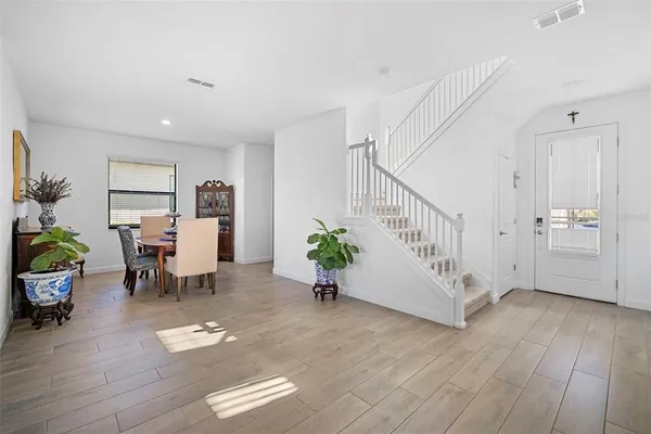 a view of a dining room with furniture and wooden floor