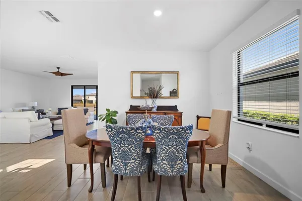 a view of a dining room with furniture and wooden floor