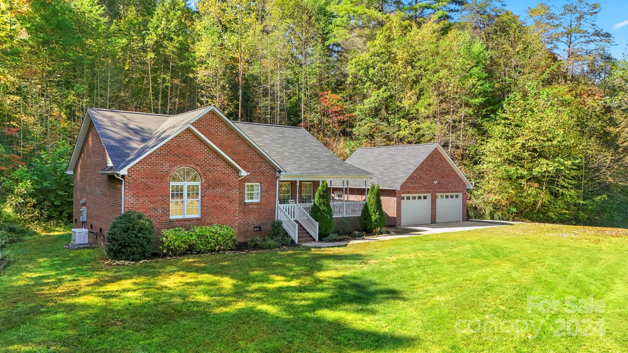 a front view of a house with a yard and trees