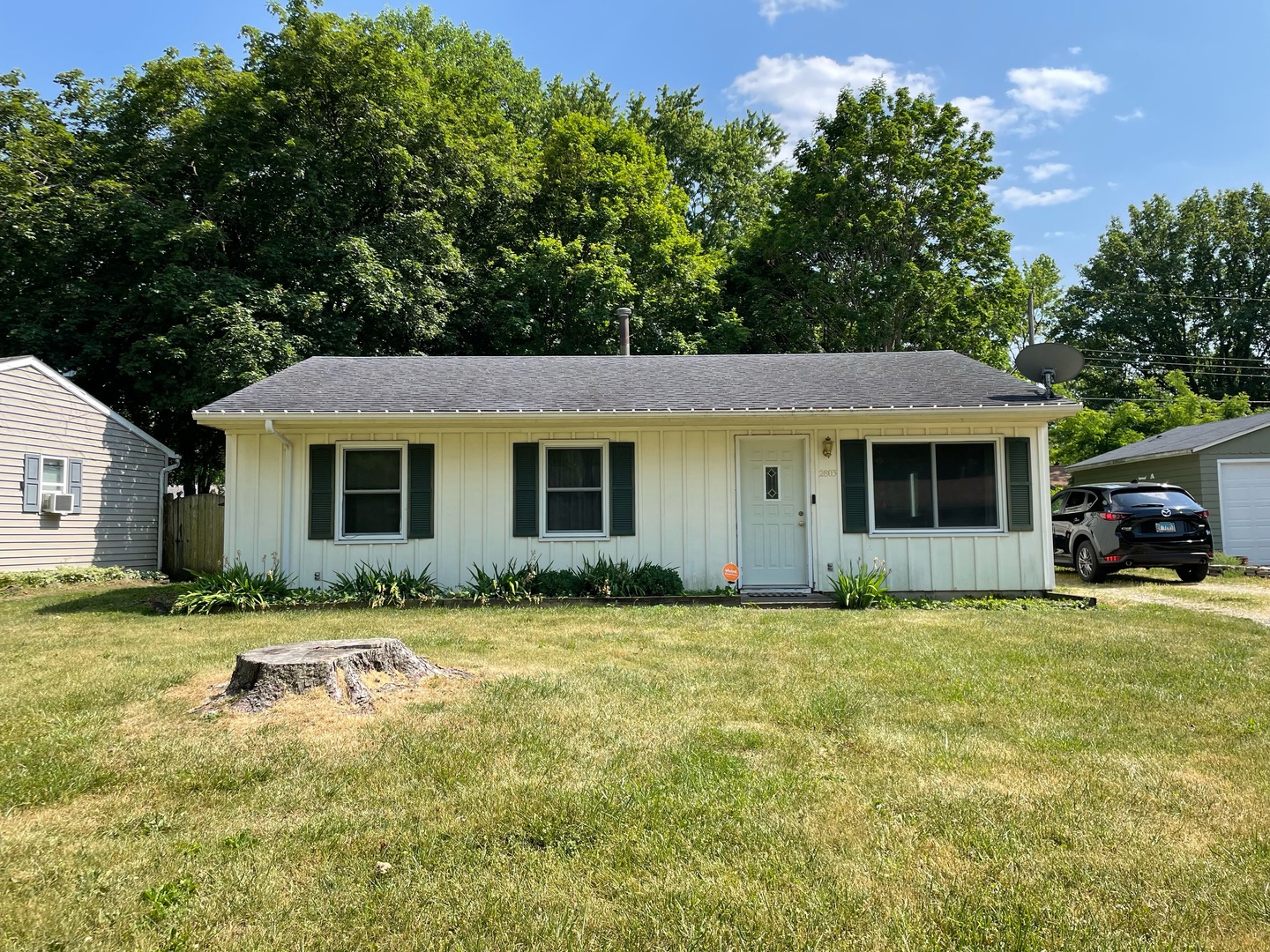 a front view of a house with a garden