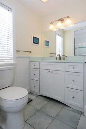 11 Old Nugent Farm Road, Unit 11 Gloucester, MA 01930 - Photo 20 of 30 a spacious bathroom with a toilet a sink a mirror a window and vanity
