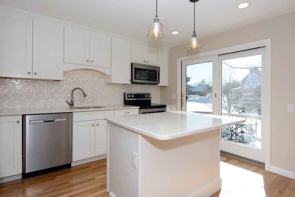 11 Old Nugent Farm Road, Unit 11 Gloucester, MA 01930 - Photo 2 of 30 a kitchen with granite countertop a sink a counter space appliances and cabinets