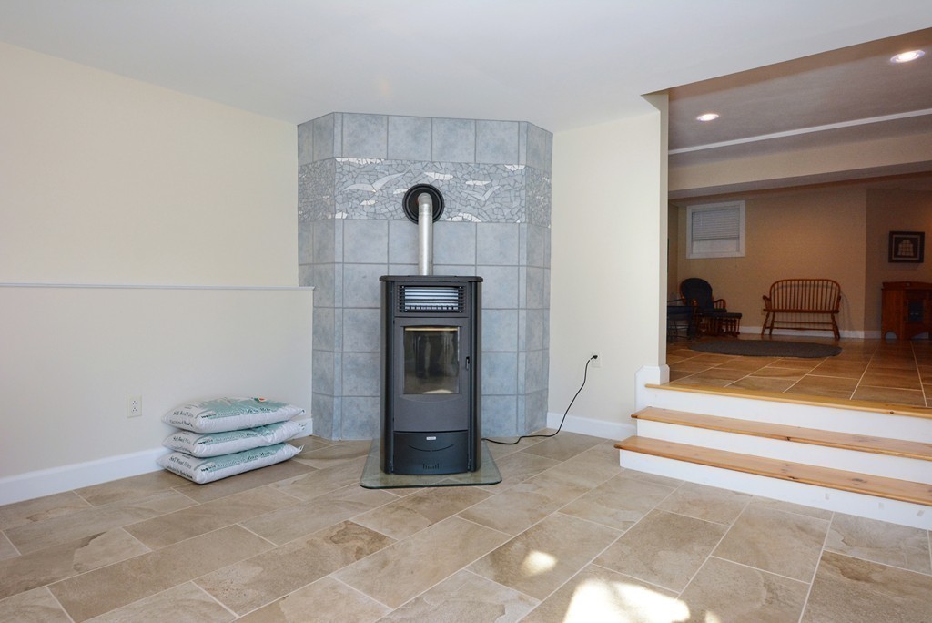 11 Old Nugent Farm Road, Unit 11 Gloucester, MA 01930 - Photo 25 of 30 a living room with a furniture and a fireplace