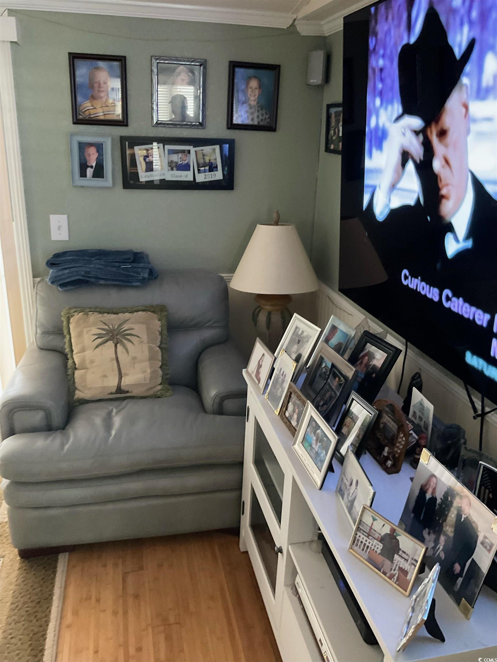 1672 Ursa Minor Drive Myrtle Beach, SC 29575 - Photo 6 of 40 Living area featuring wood finished floors and crown molding