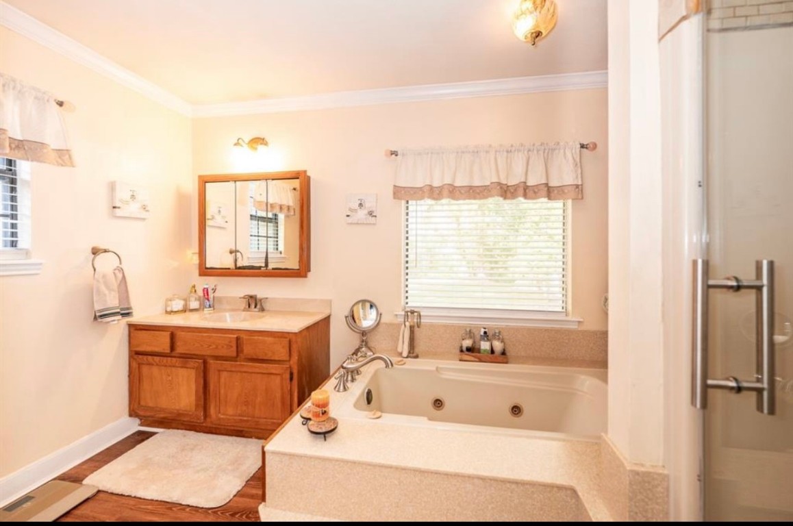464 River Road Angleton, TX 77515 - Photo 11 of 45 a bathroom with a tub sink and mirror