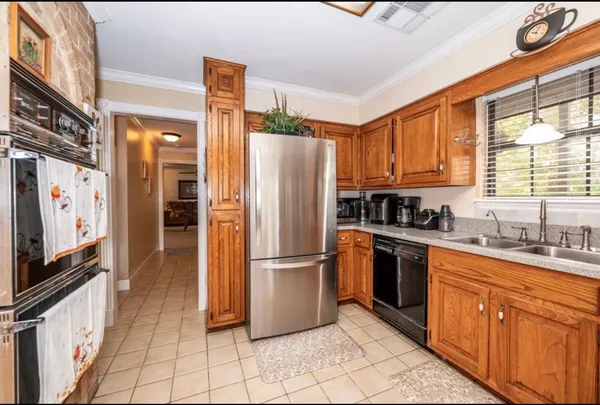 a kitchen with stainless steel appliances granite countertop a refrigerator stove and sink