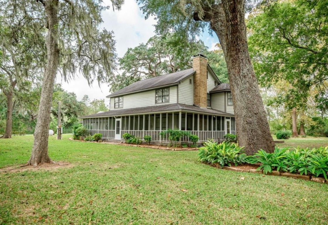 464 River Road Angleton, TX 77515 - Photo 3 of 45 a view of a house with a yard and plants