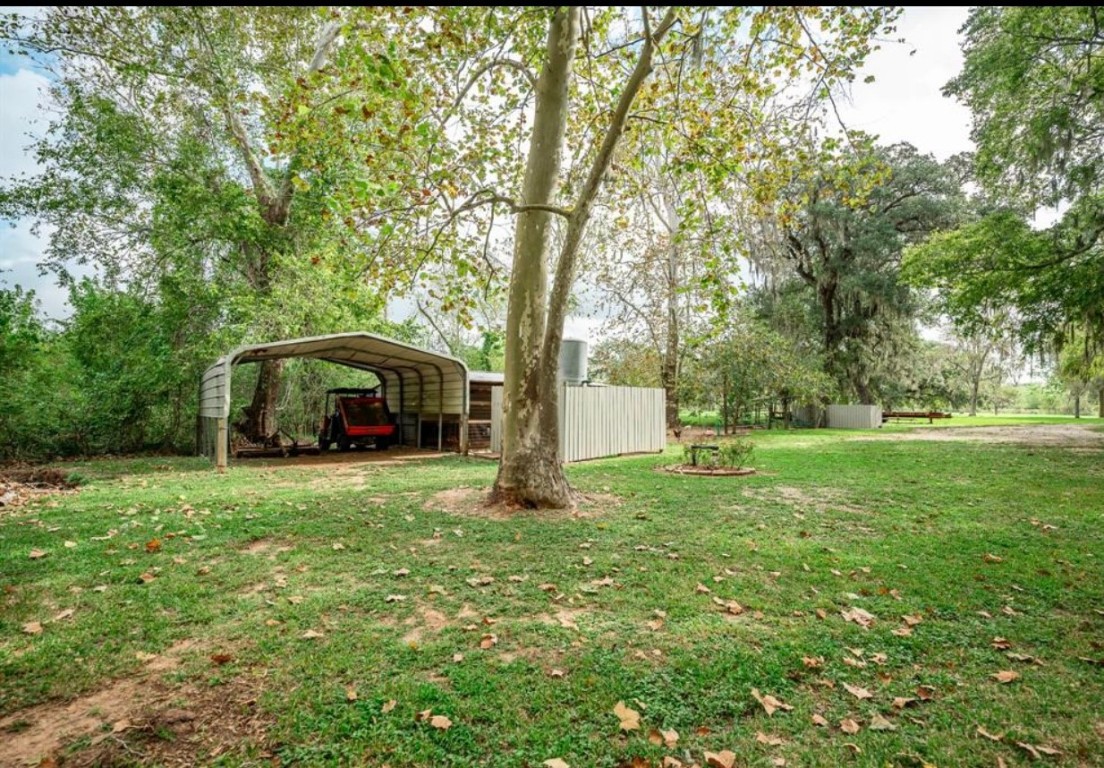 464 River Road Angleton, TX 77515 - Photo 36 of 45 a view of a house with backyard and trees
