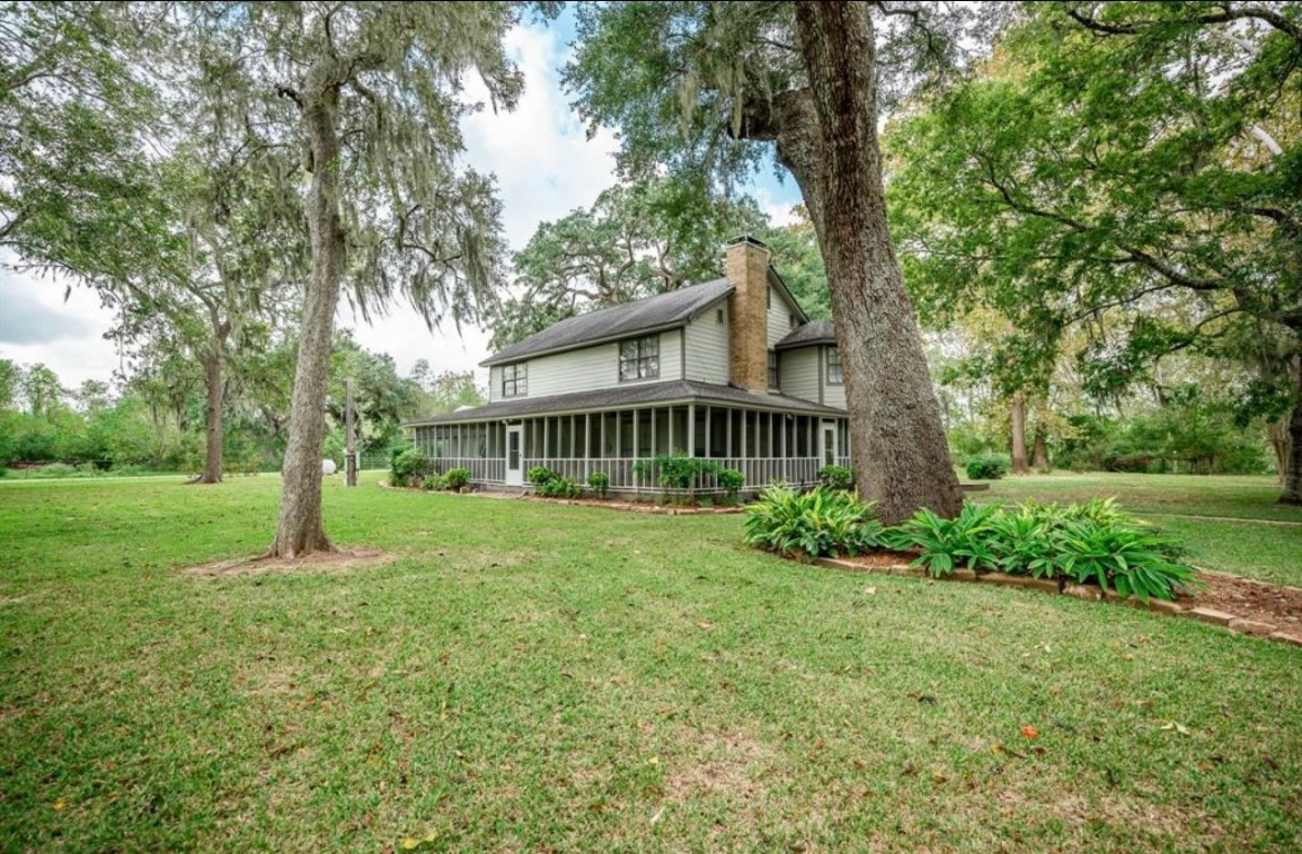 464 River Road Angleton, TX 77515 - Photo 38 of 45 a view of a house with backyard and a tree