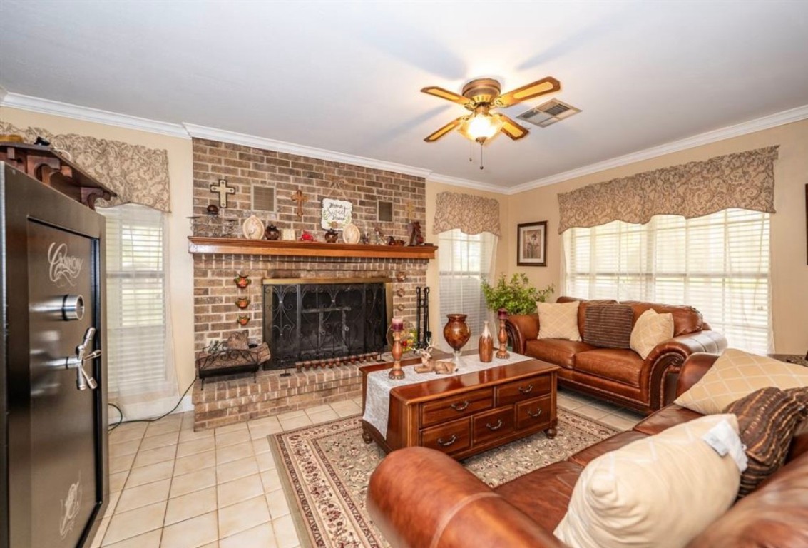 464 River Road Angleton, TX 77515 - Photo 7 of 45 a living room with furniture a fireplace and a large window