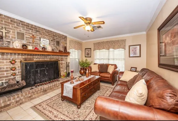 a living room with furniture a window and a fireplace