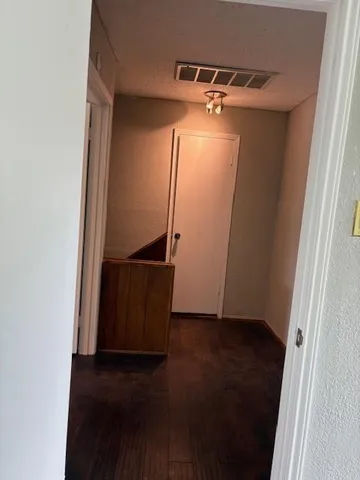 an empty room with wooden floor and a window