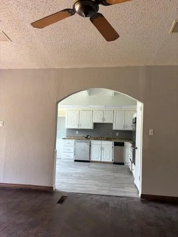 a living room with a couch and a stove with wooden floor
