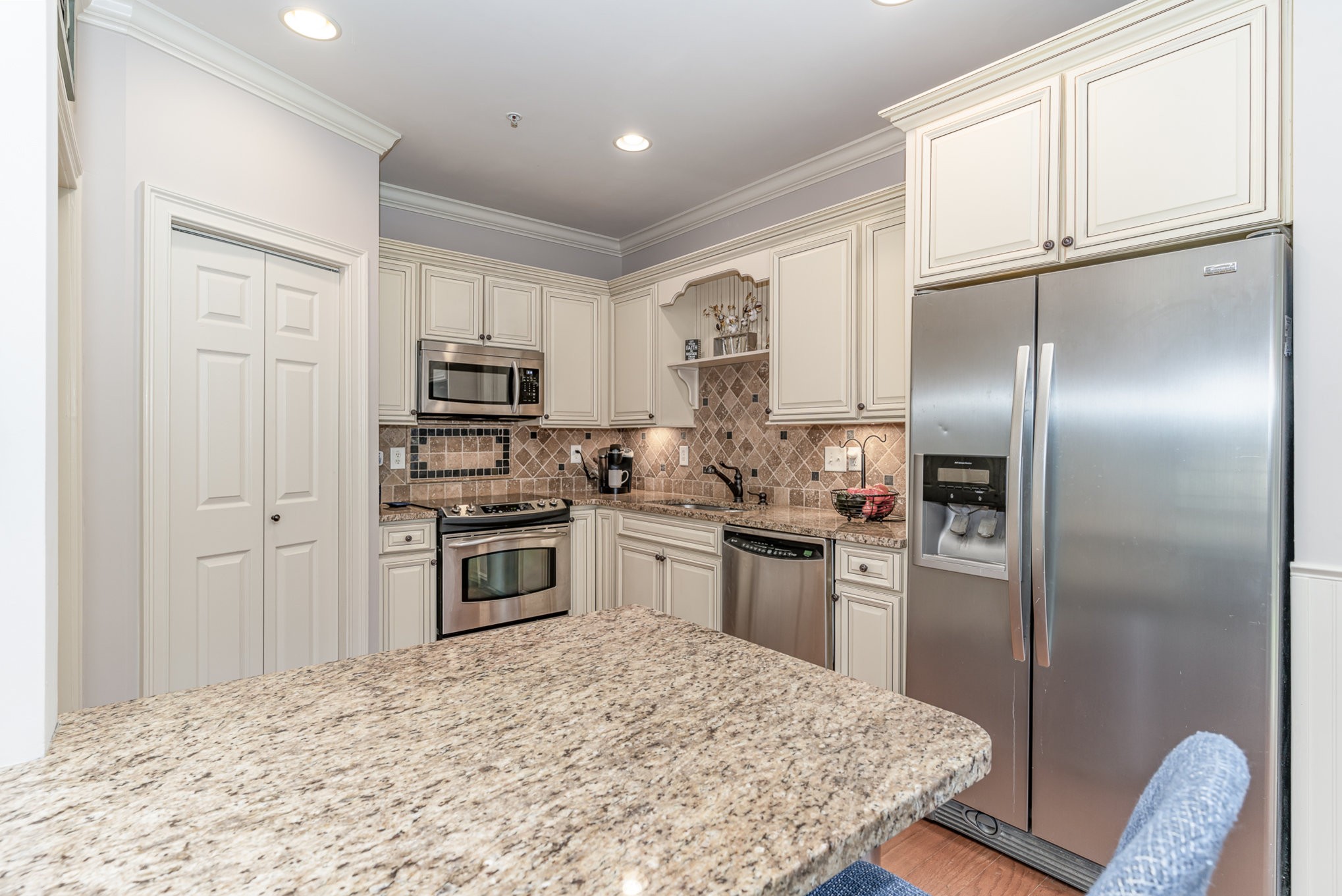 4229 Prestwick Place Spring Hill, TN 37174 - Photo 13 of 29 a kitchen with granite countertop a refrigerator stove and microwave