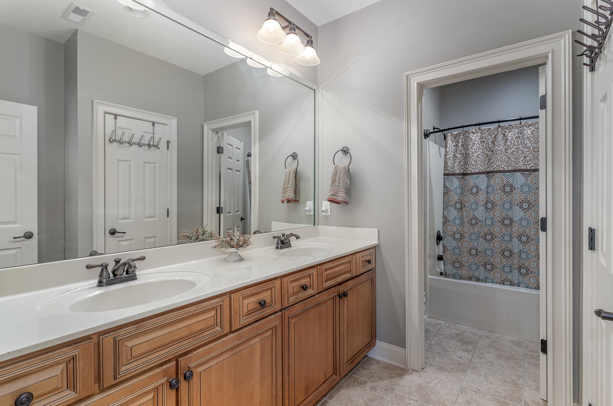 4229 Prestwick Place Spring Hill, TN 37174 - Photo 21 of 29 a bathroom with a sink double vanity and a shower