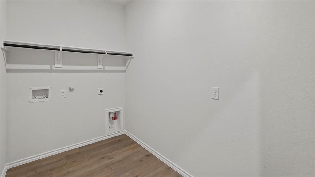 1627 Mantle Road Crandall, TX 75114 - Photo 24 of 40 Laundry area featuring wood-finish flooring, white walls, and an integrated shelf with hanging rod