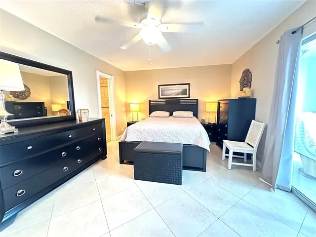 a bedroom with a bed and a dresser with mirror