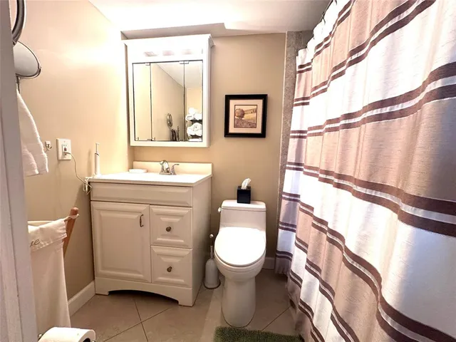 a bathroom with a toilet a sink and a mirror