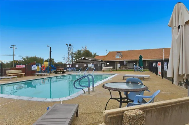 a view of a swimming pool with seating area