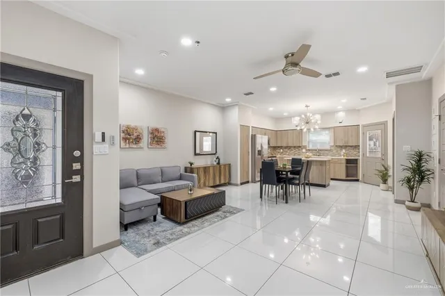 a living room with furniture and a dining table with kitchen view