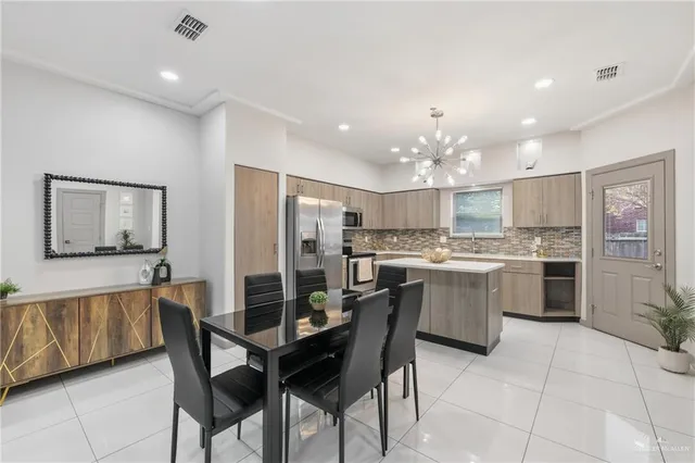 a kitchen with a table and chairs in it
