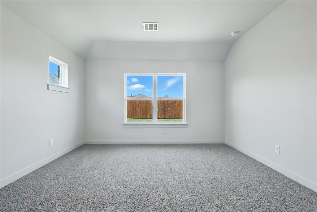 1795 Gleasondale Place Forney, TX 75126 - Photo 15 of 29 Spare room with carpet and vaulted ceiling