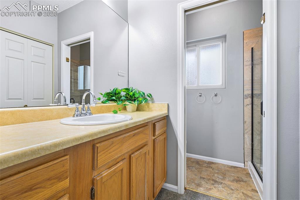 365 Autumn Ridge Circle, Unit A Colorado Springs, CO 80906 - Photo 21 of 30 with attached 3/4 bath & plenty of cabinets and counter space.