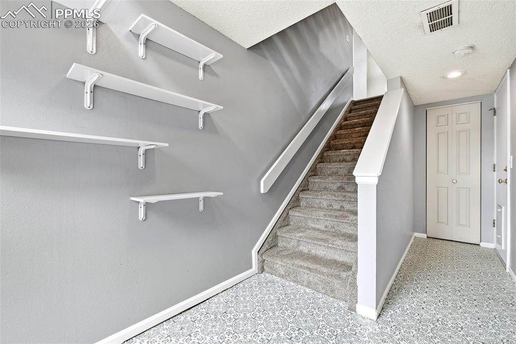 365 Autumn Ridge Circle, Unit A Colorado Springs, CO 80906 - Photo 22 of 30 The basement flex space and unfinished storage area with direct garage access...