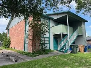 a view of a wooden house with a small yard