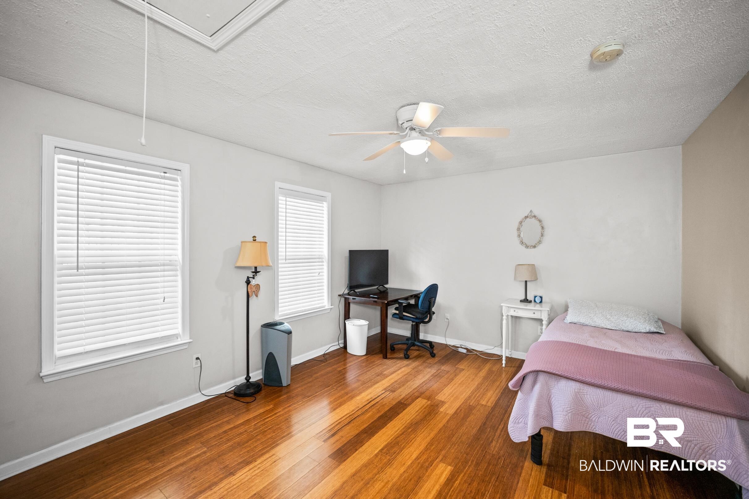 123 Dunbar Loop Daphne, AL 36526 - Photo 25 of 33 Bedroom featuring attic access, a textured ceiling, wood-type flooring, a desk, and a ceiling fan